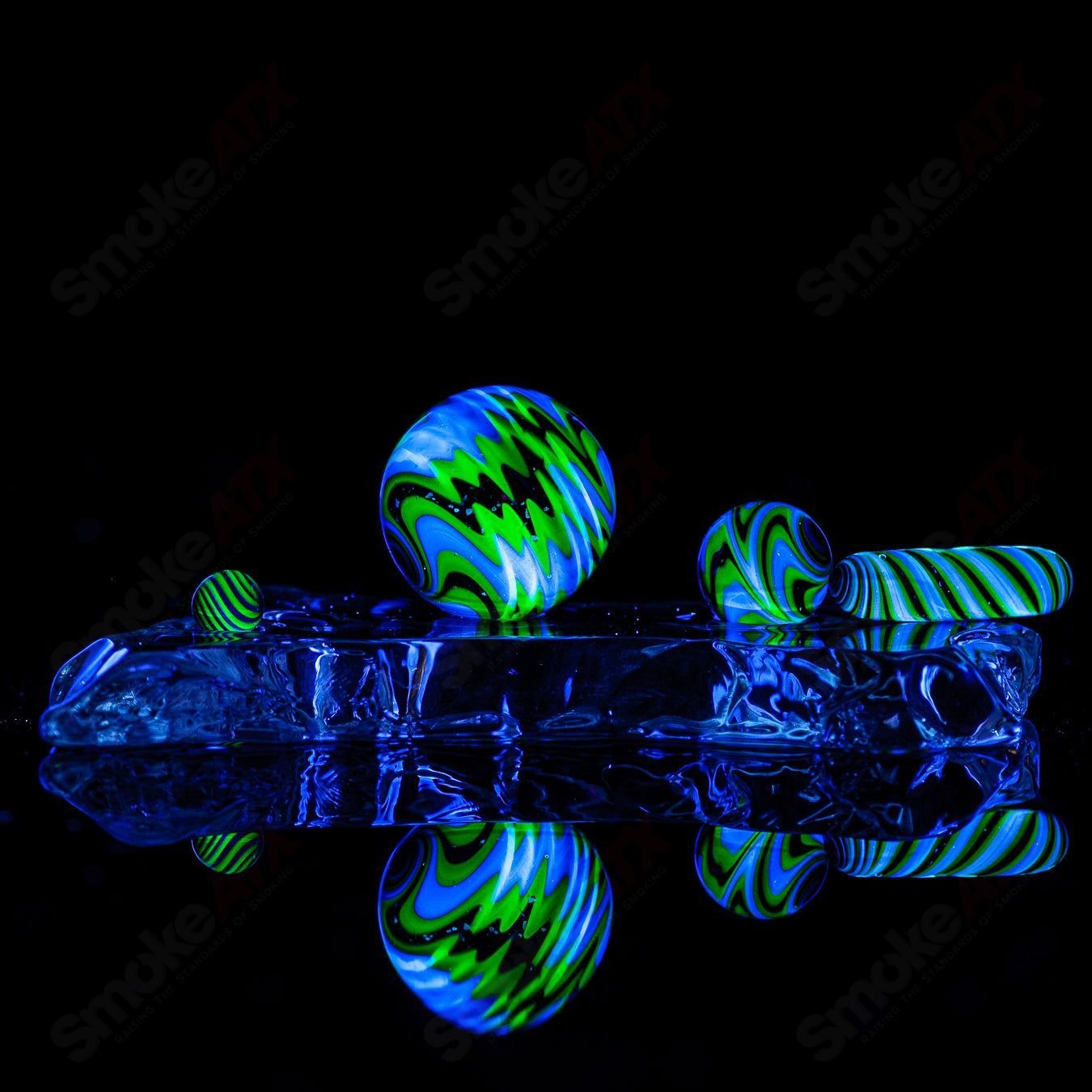 Set of four Indo Glass UV Black Magic Galaxy, Citrine, and Lucy slurpers for glass accessories, featuring vibrant colors and detailed design.