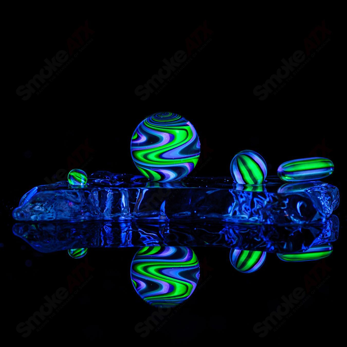 Set of four UV-reactive glass slurpers including Ghost, Citrine, Lucy, Galaxy, and Karmaline from Indo Glass accessories.