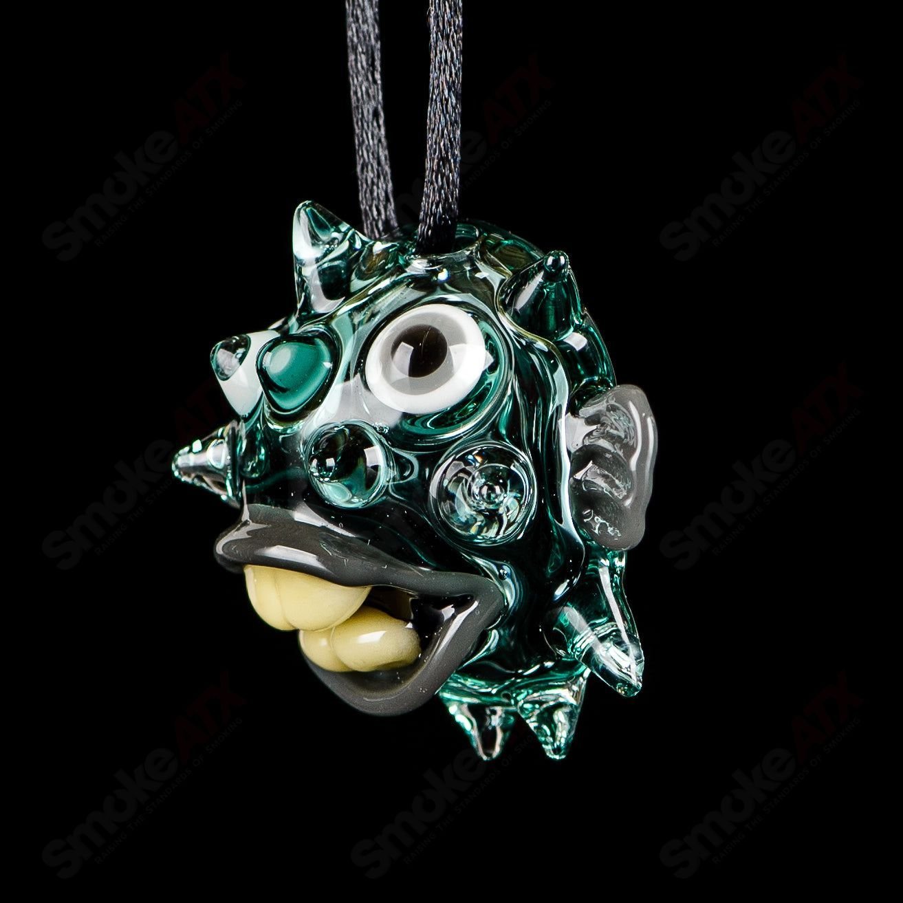 Chadd Lacy Glass #5 Puffer Pendant featuring colorful glass artwork, hanging from a metal chain, in a close-up view.