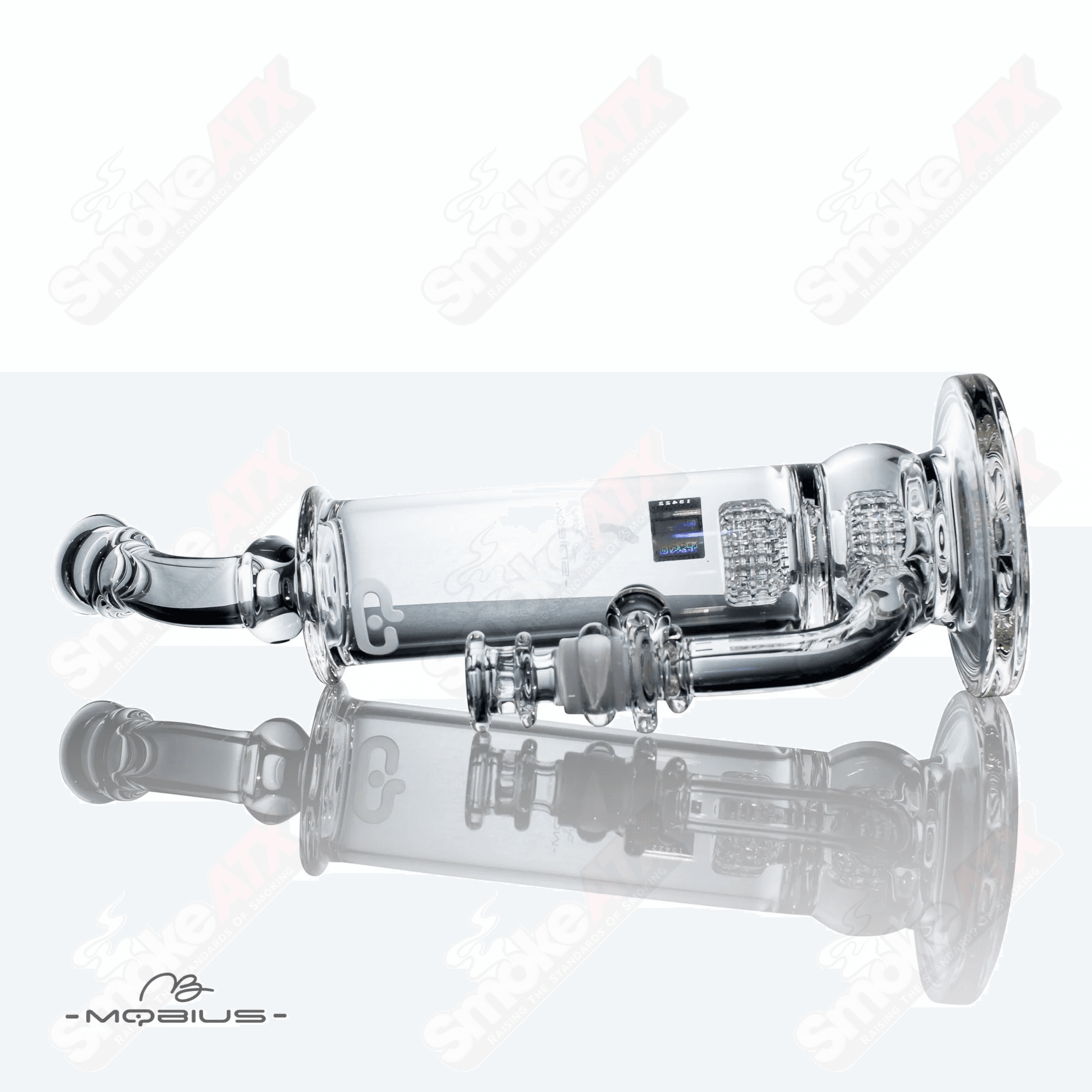 Glass waterpipe with stereo matrix design by Mobius, featuring intricate glasswork and a sleek, transparent style.