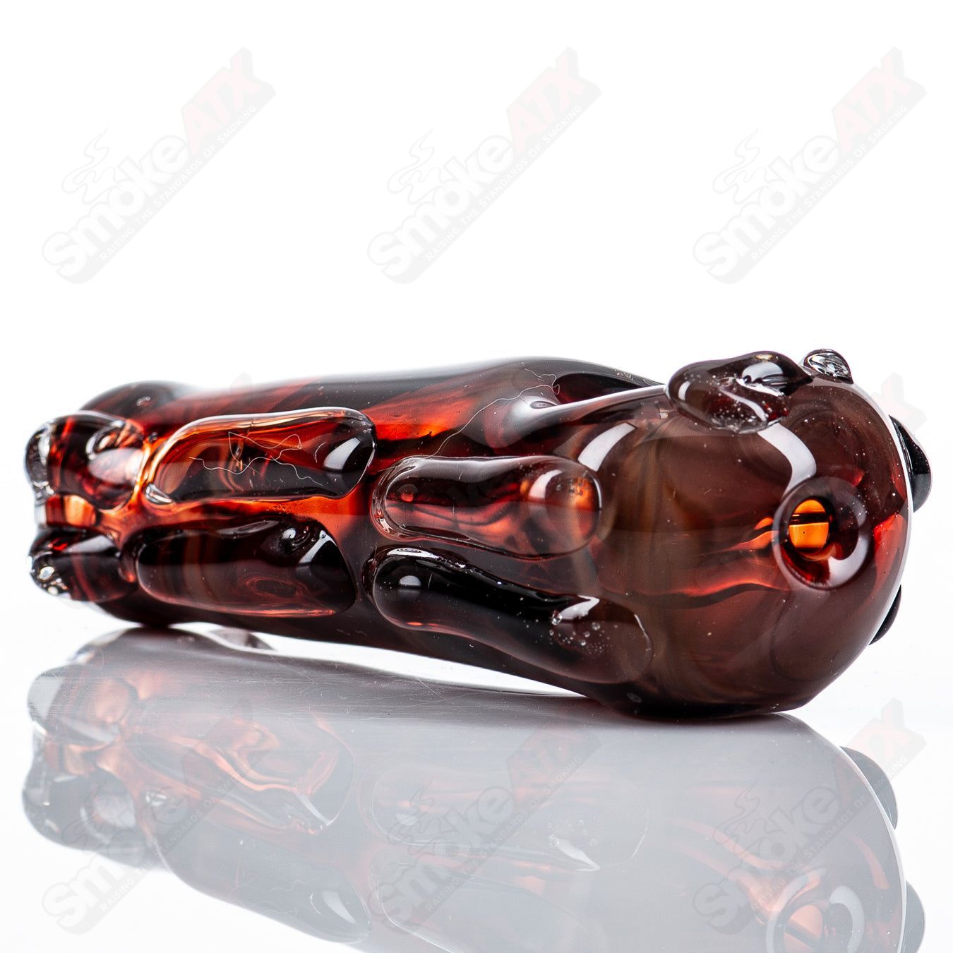 Glass pipe with spoon-shaped bowl, clear glass design by Nobody, showcasing smooth curves and craftsmanship.