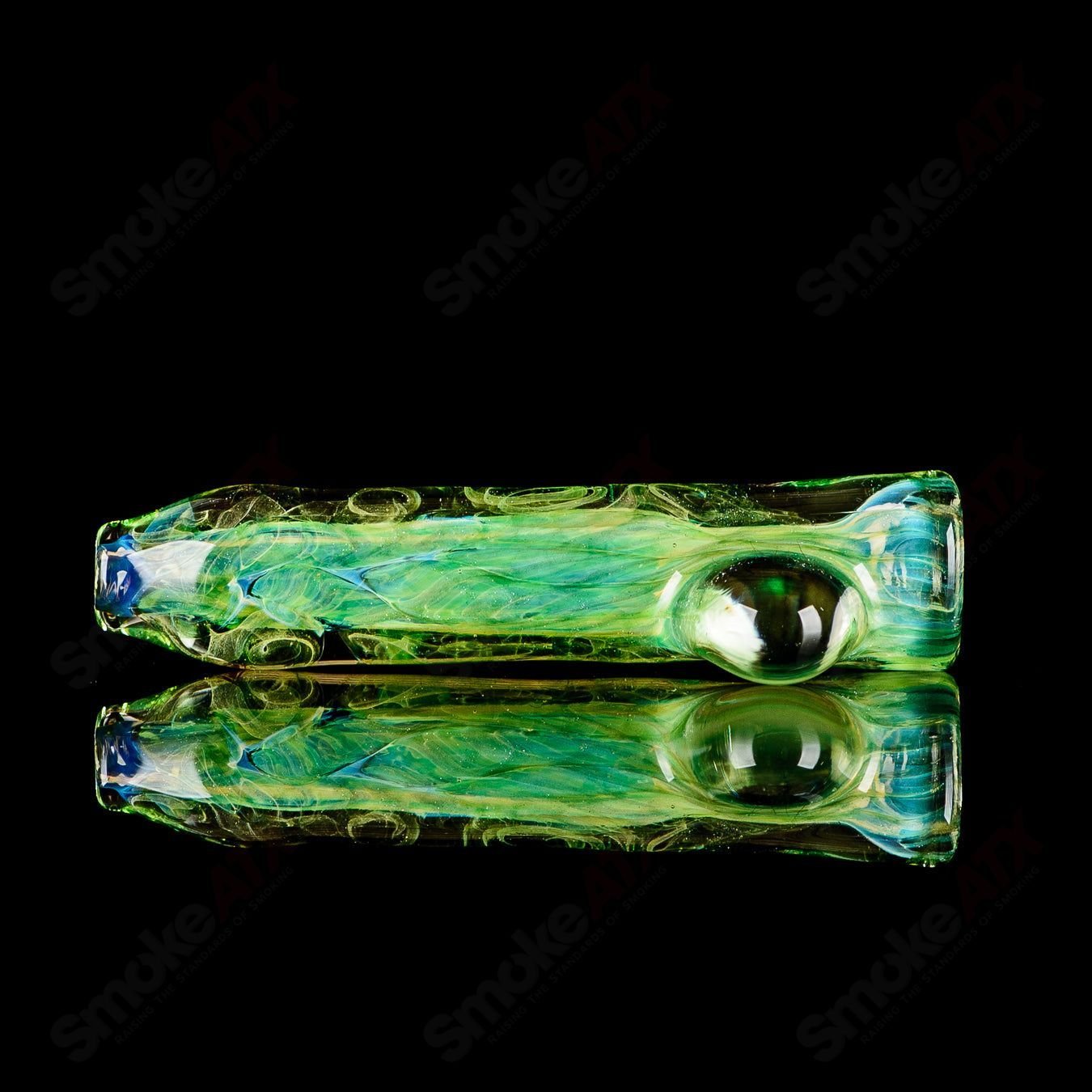 JMK Glass signed #7 I/O Worked Chillum made of clear glass with intricate worked design, displayed on a plain background.