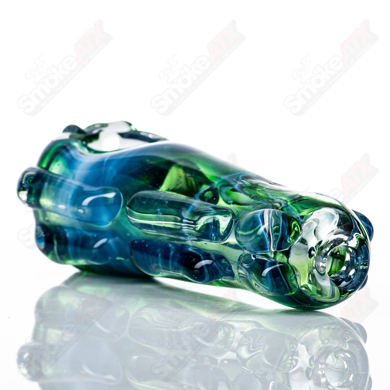 Close-up of the #77 Spoon Glass pipe by Nobody, featuring clear glass with a rounded bowl and smooth design.