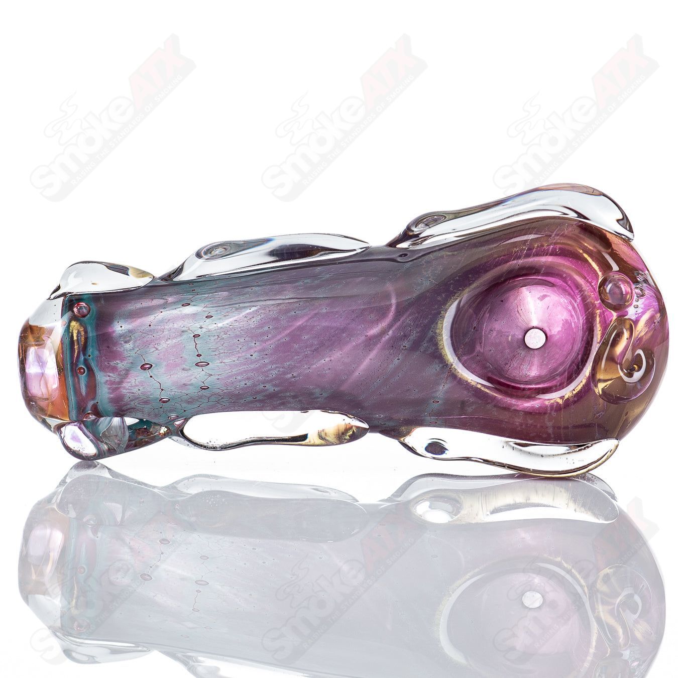 Glass pipe called the 79-Key Spoon by Nobody, featuring clear glass with intricate design details, used for smoking.