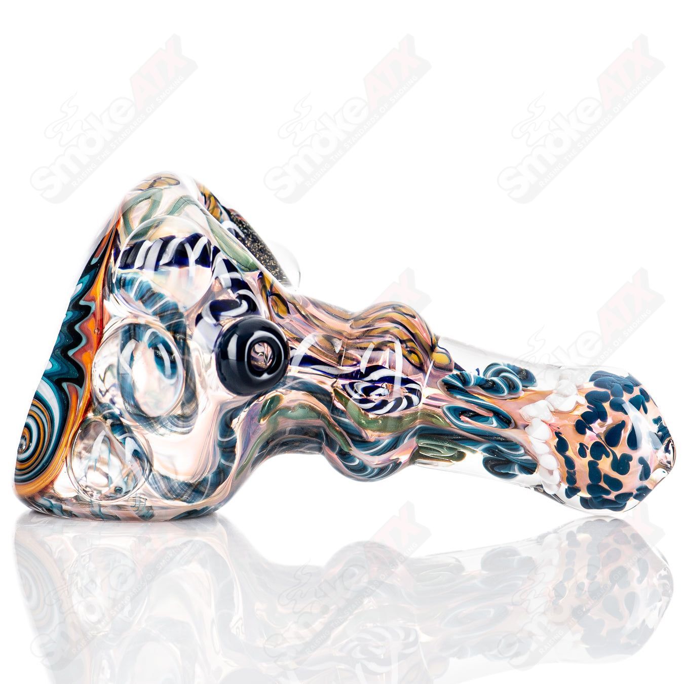 Molten Imagination custom glass spoon called the ISO Chaos Hammer, featuring a vibrant, artistic design and clear glass craftsmanship.