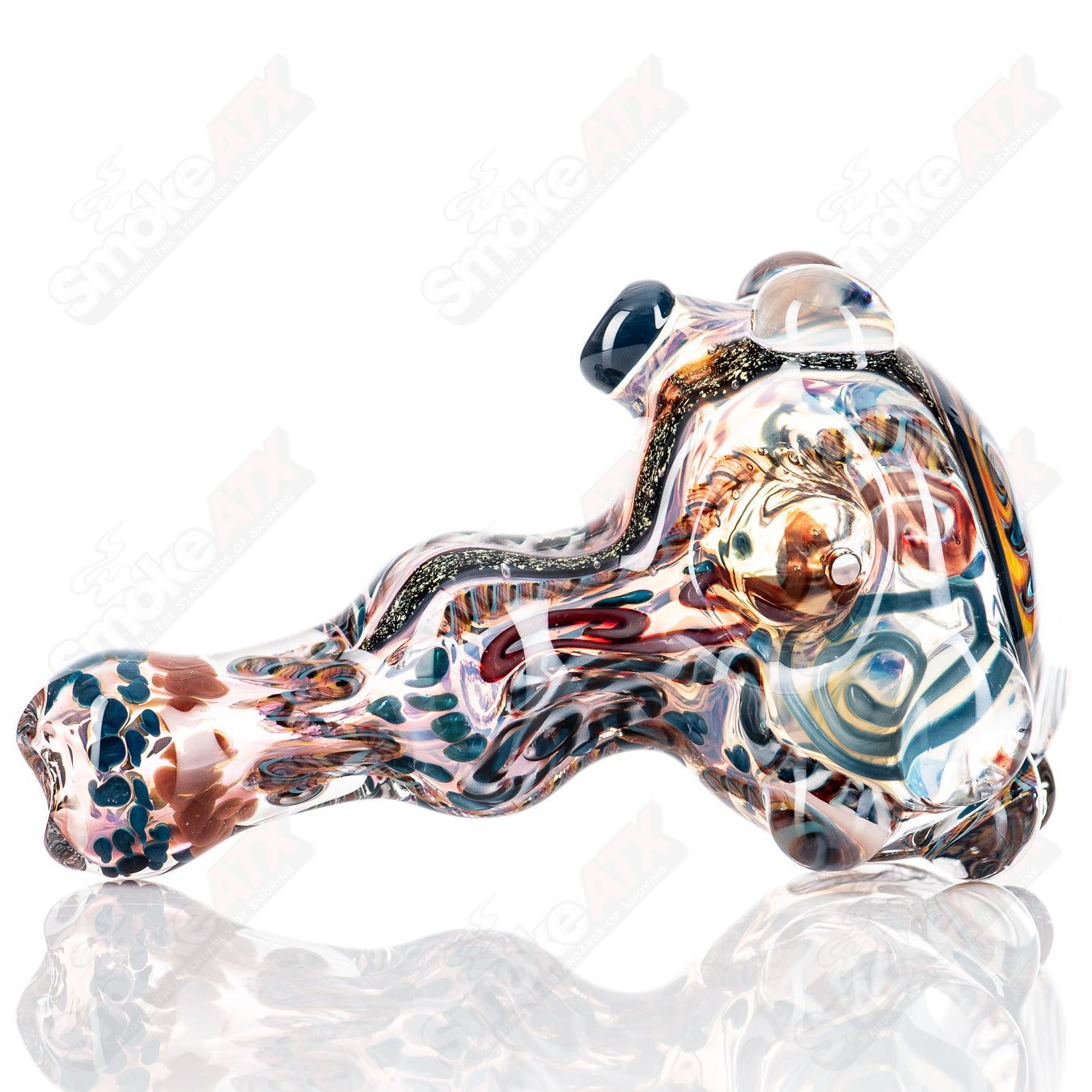 Molten Imagination Custom Glass Creations ISO Chaos Hammer Spoon, hand-blown glass art with intricate design and vibrant colors.
