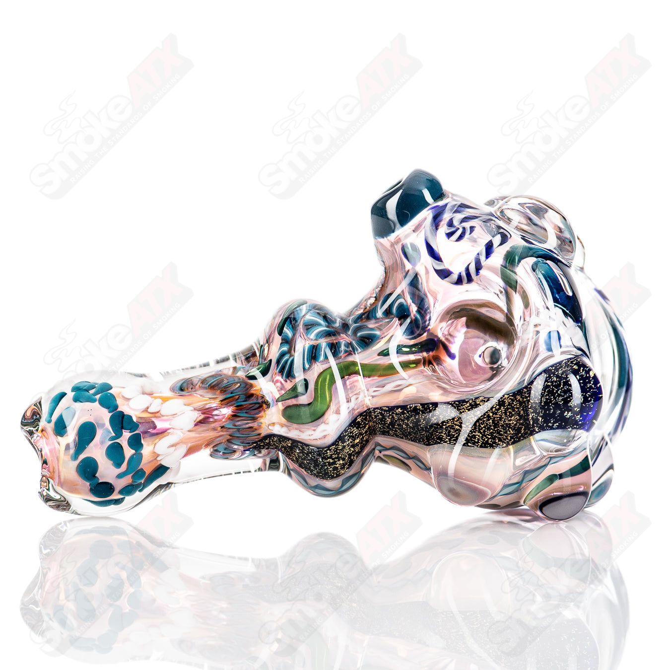 Molten Imagination Custom Glass Creations ISO Chaos Hammer Spoon, handcrafted glass art with a textured, intricate design.