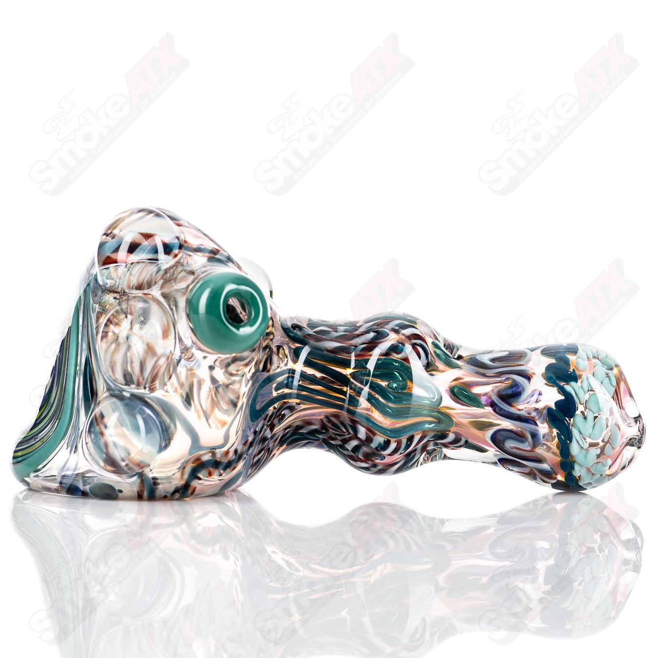 Molten Imagination Custom Glass Creations ISO Chaos Hammer Spoon featuring a colorful, abstract glass design and unique hammer shape.