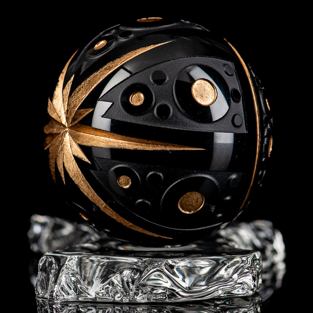 Black marble glass marbles from Fatal Facets Battuto x Fatal Facets collection, showcasing smooth, glossy surface and rounded shape.