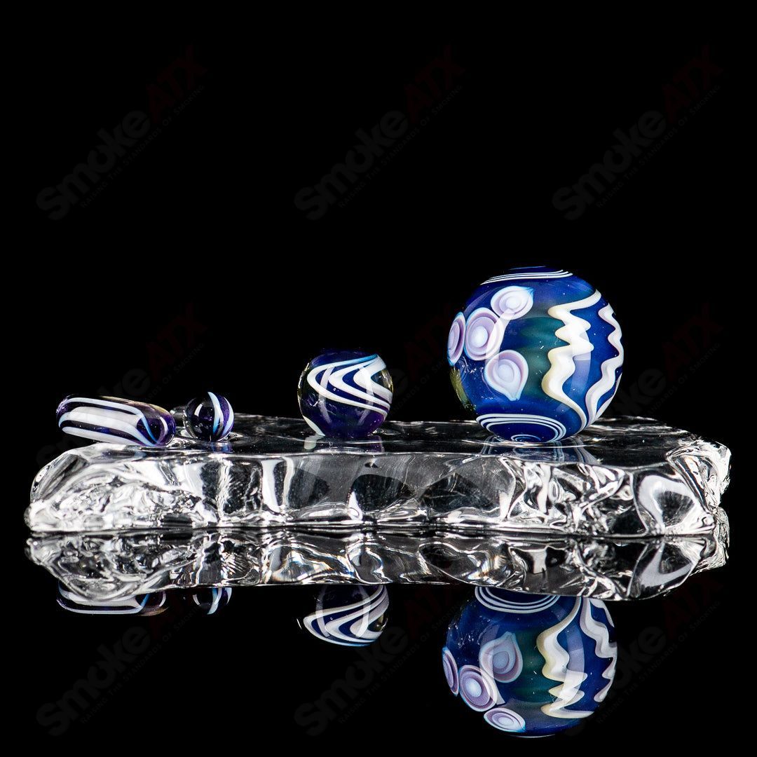 Indo Glass UV Dotstack Slurper Set featuring colorful glass tools for dabbing and vaporizing concentrates.