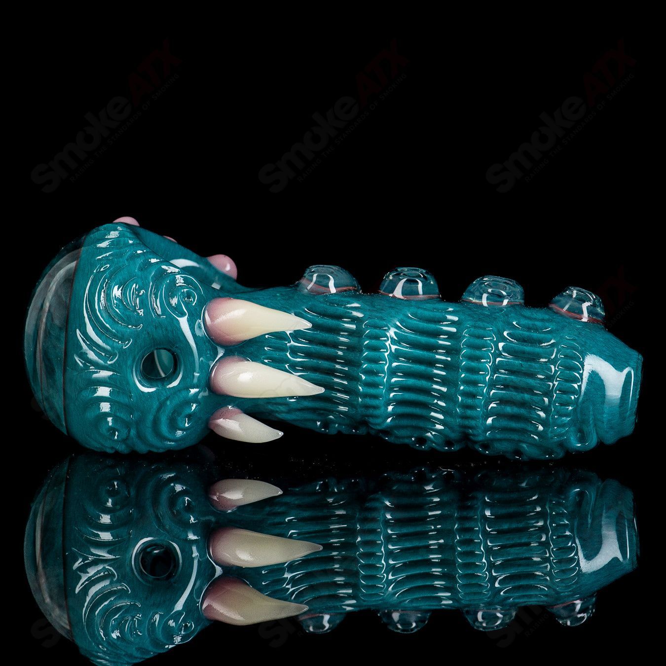 Aqua Azul Ether Spoon hand pipe by Salt Glass, featuring vibrant blue glass and intricate design, showcasing smooth curves and craftsmanship.