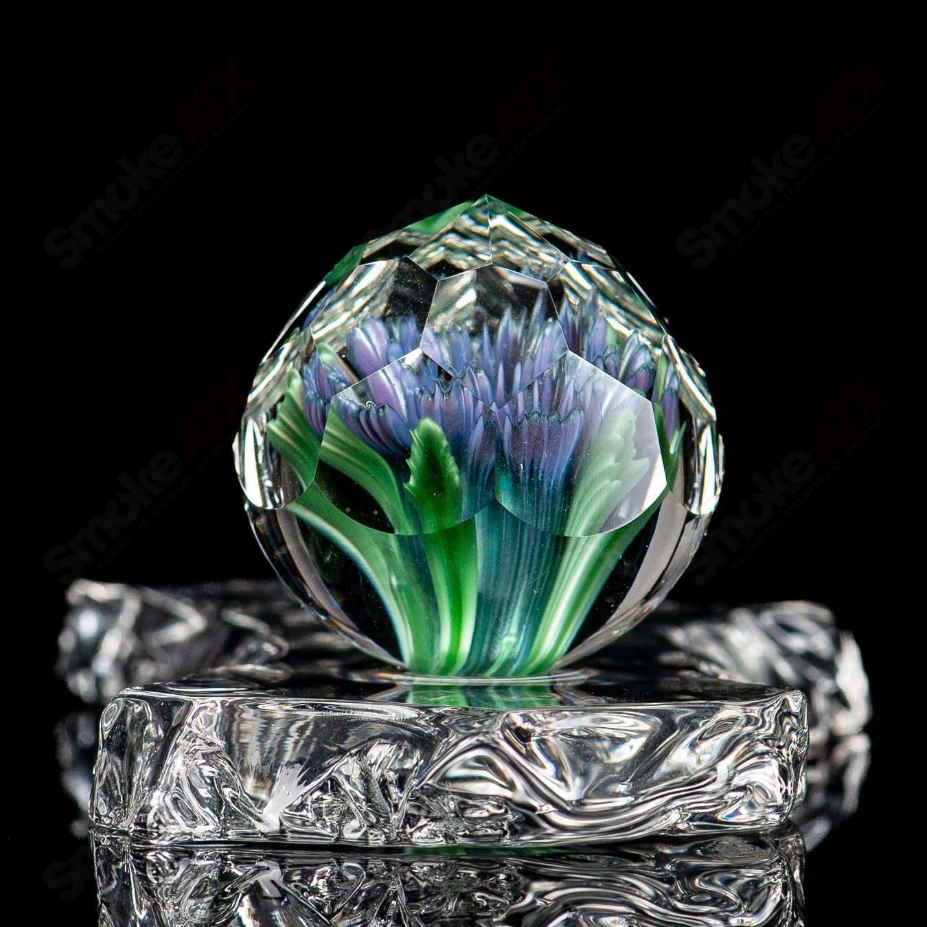 Glass marbles featuring flower and marble designs from Fatal Facets, showcasing colorful glass impacts and intricate facets.