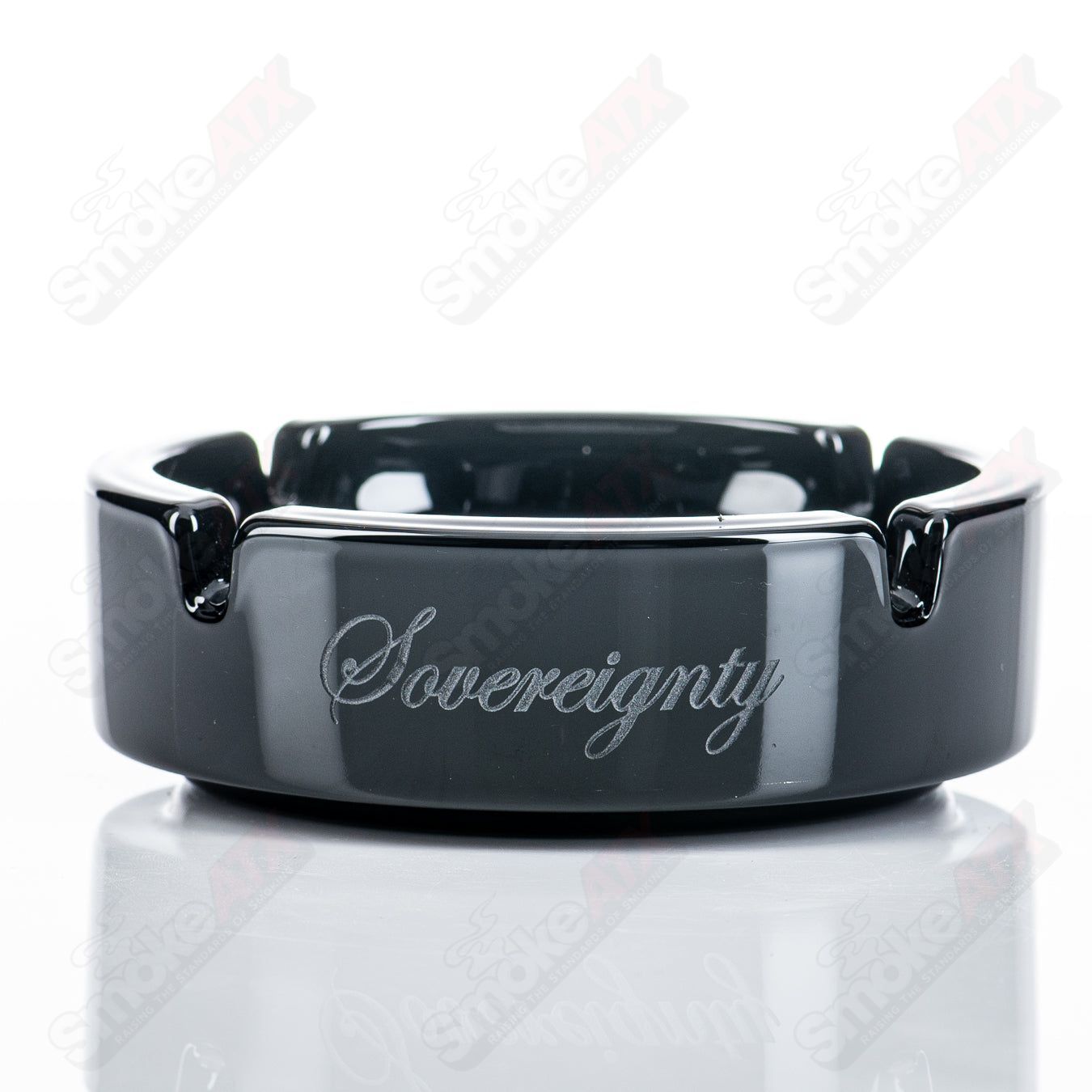 Black glass ashtray featuring a bloodshed skull and circle pattern, designed by Sovereignty Glass for 420 enthusiasts.