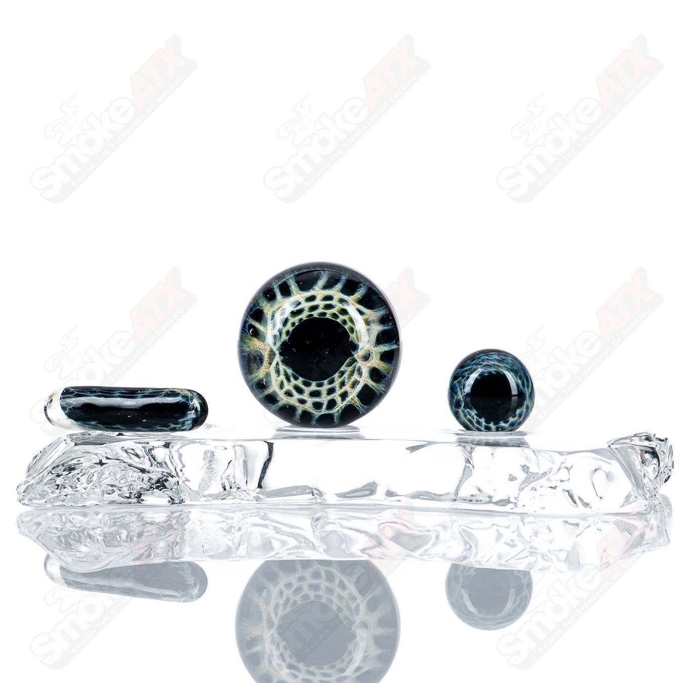 Black Magic Eye Slurper Set by Indo Glass featuring clear glass accessories with black and white eye designs.