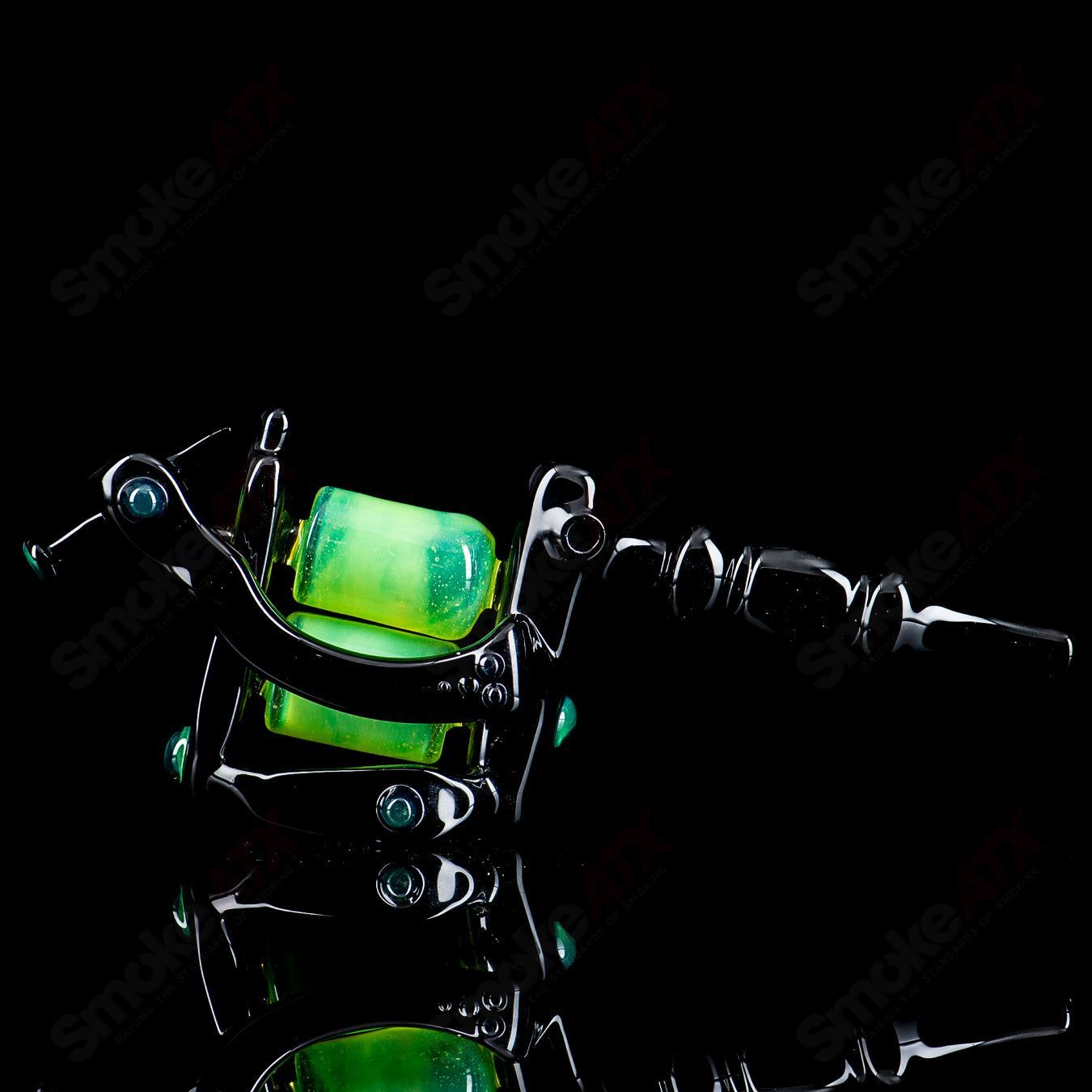 Black and slime-colored tattoo gun rig by JMass, a stylish heady glass concentrate rig with intricate details and a sleek design.