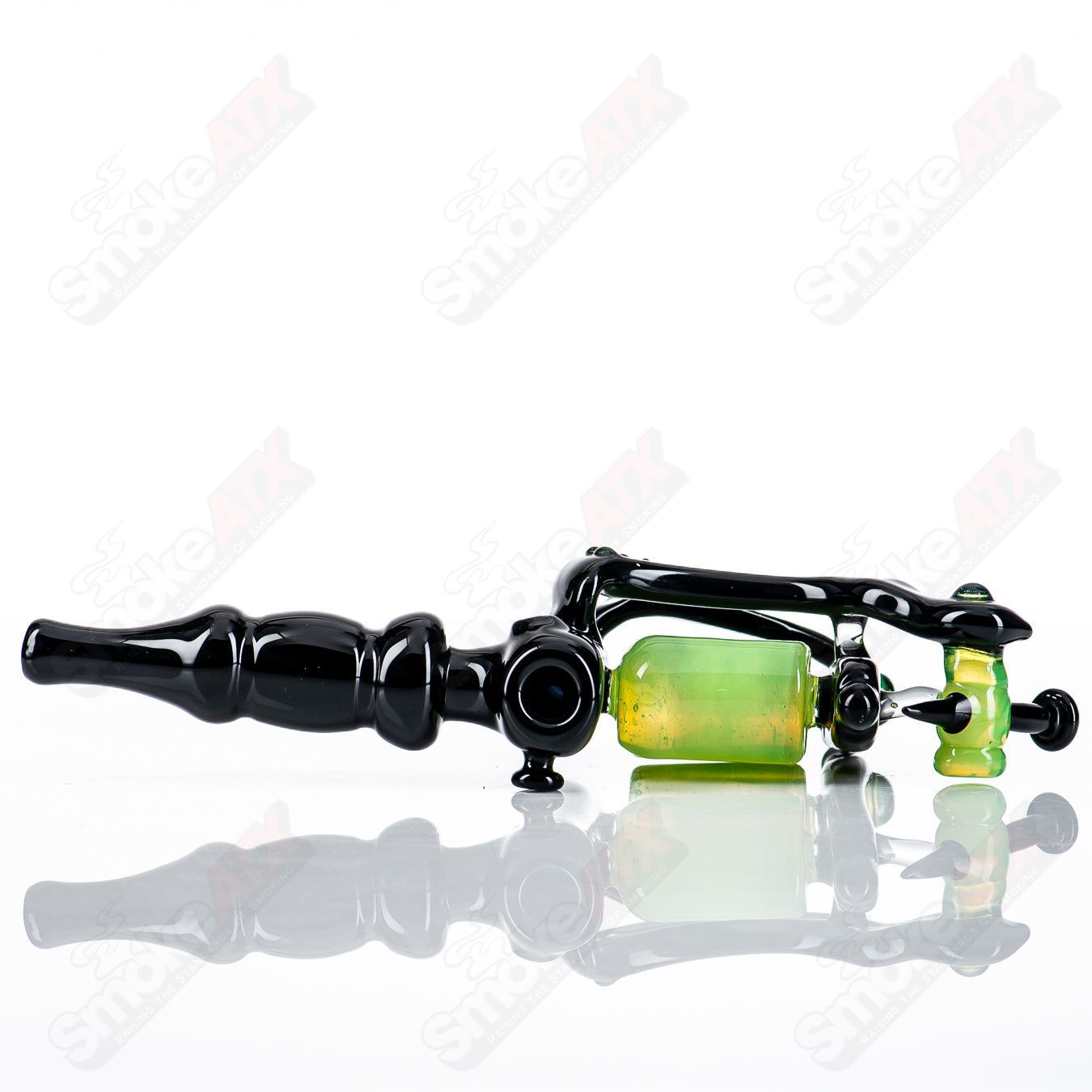 Black and slime-colored tattoo gun-shaped concentrate rig by JMass, featuring intricate glass design and detailed craftsmanship.