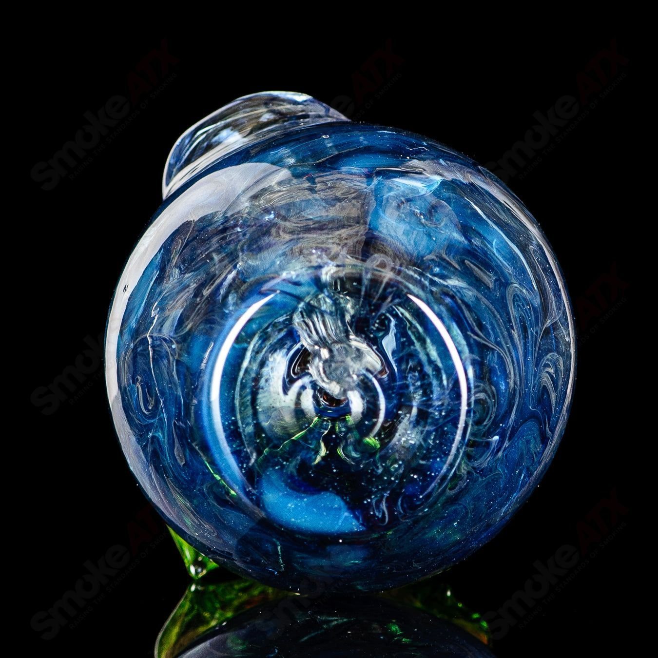Blue apple-shaped concentrate rig by Pouch Glass with a worm dabber and matching pouch, made of colorful heady glass.