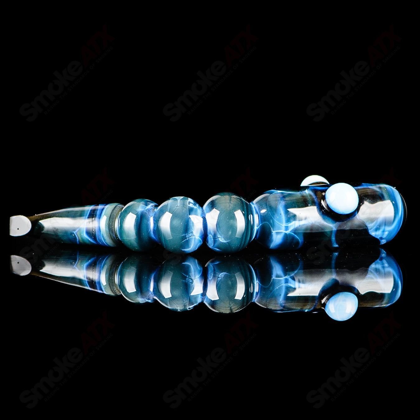 Blue apple-shaped concentrate rig with worm dabber pouch by Pouch Glass, made of clear glass, featuring colorful apple and worm details.