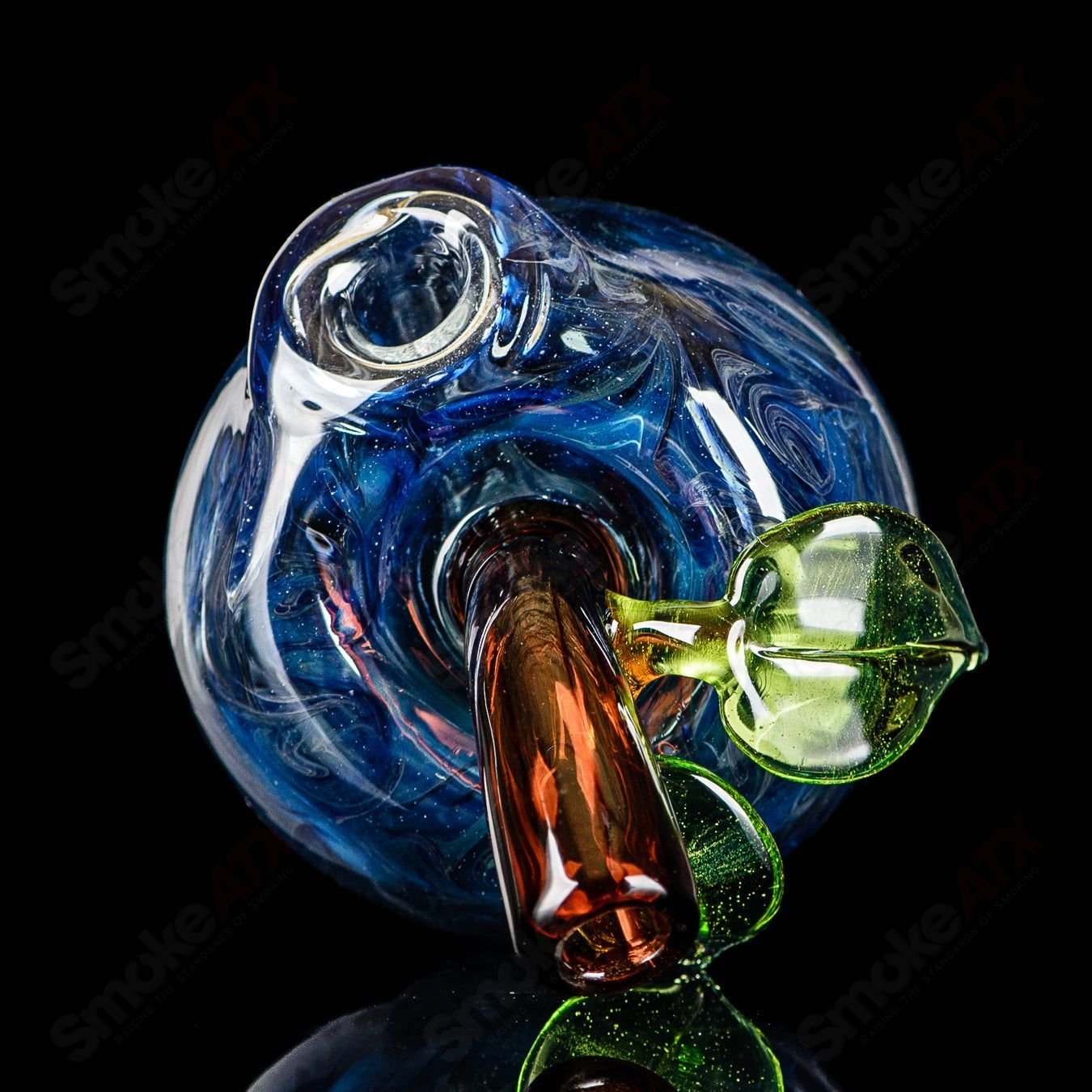Blue glass apple-shaped rig with a worm dabber and pouch, designed for concentrate use by Pouch Glass, featuring intricate heady glass details.