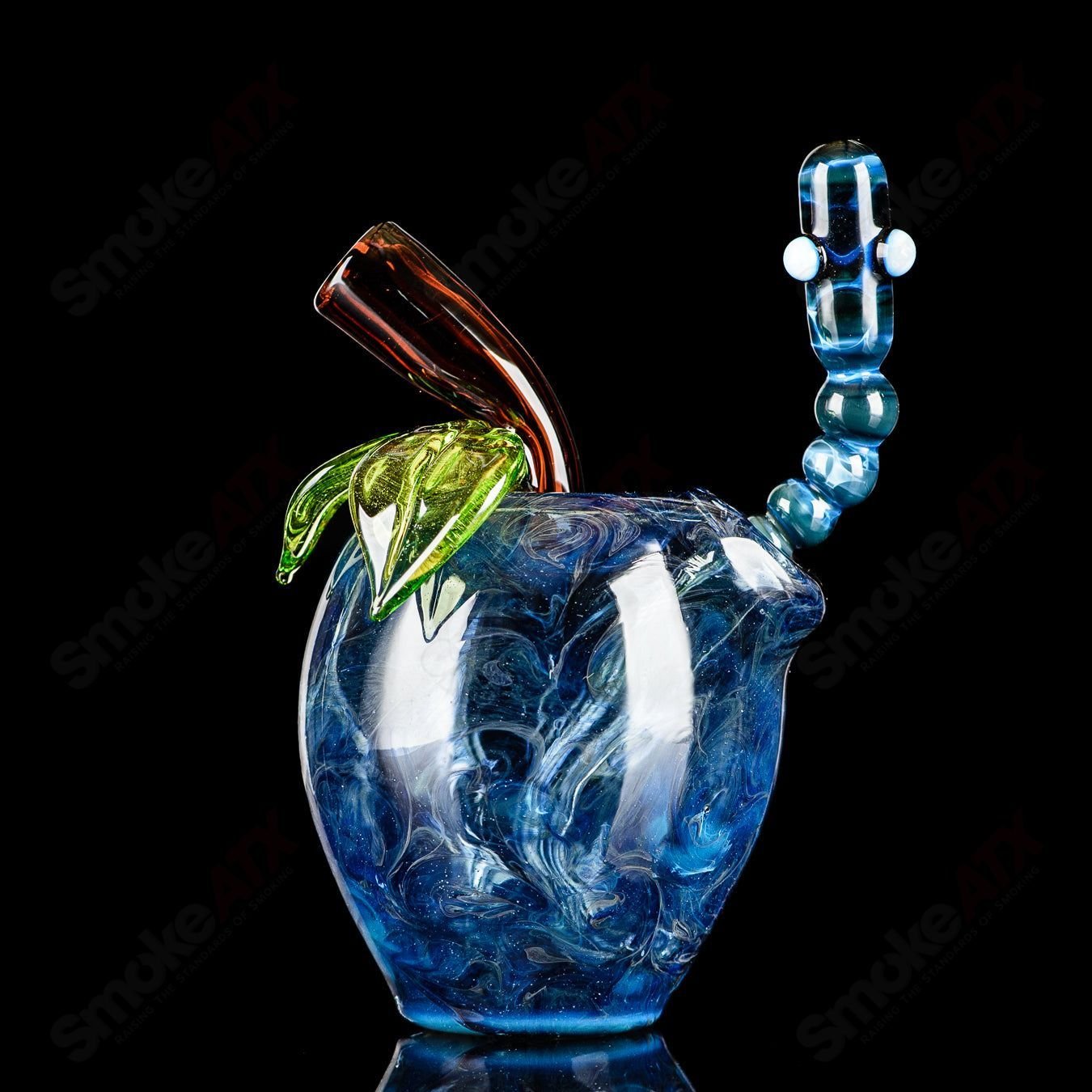 Blue apple-shaped concentrate rig with worm dabber and pouch glass, featuring intricate heady glass design for dabbing.