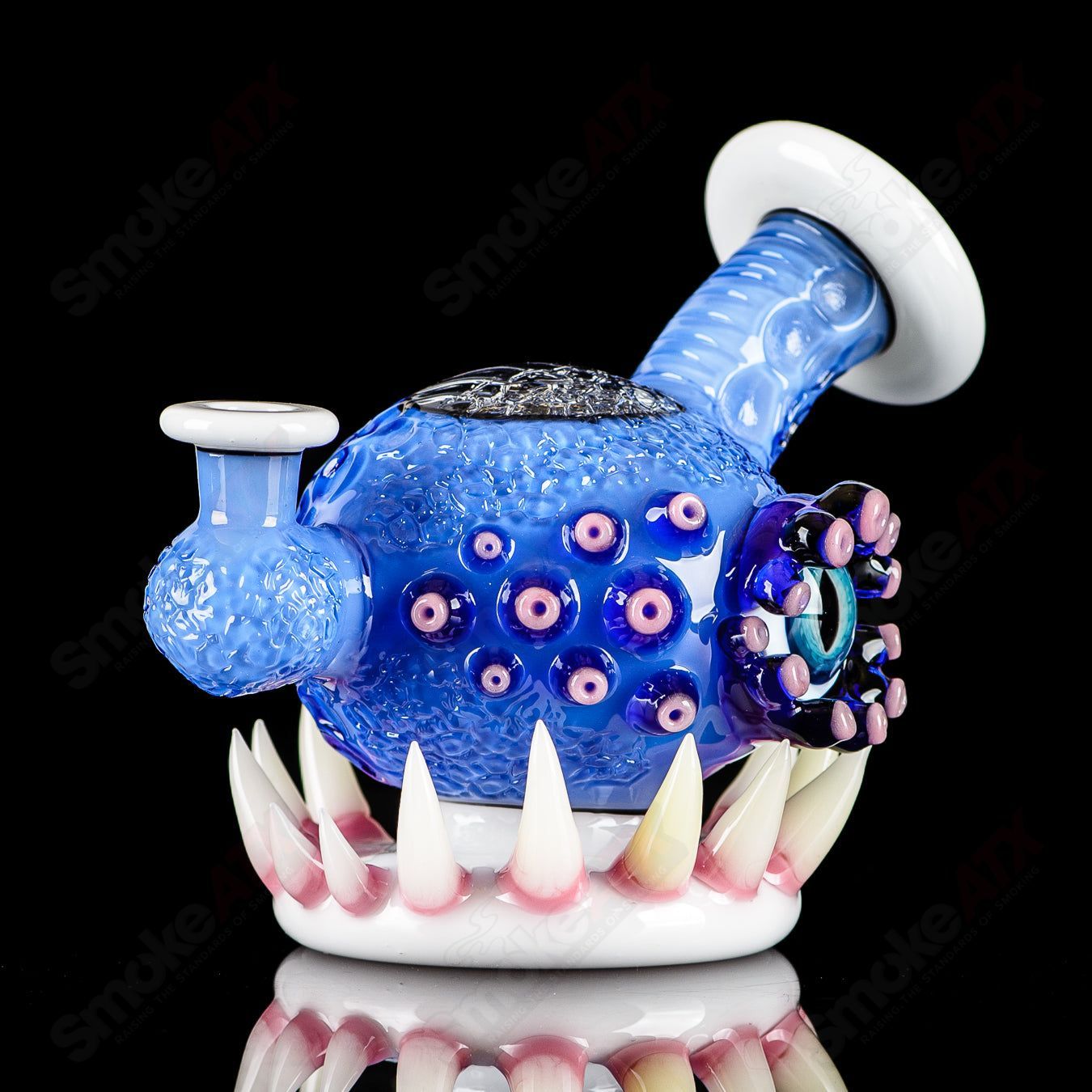 Brilliant blue orb-shaped concentrate rig by SALT & JAG, made of heady glass with intricate design details.