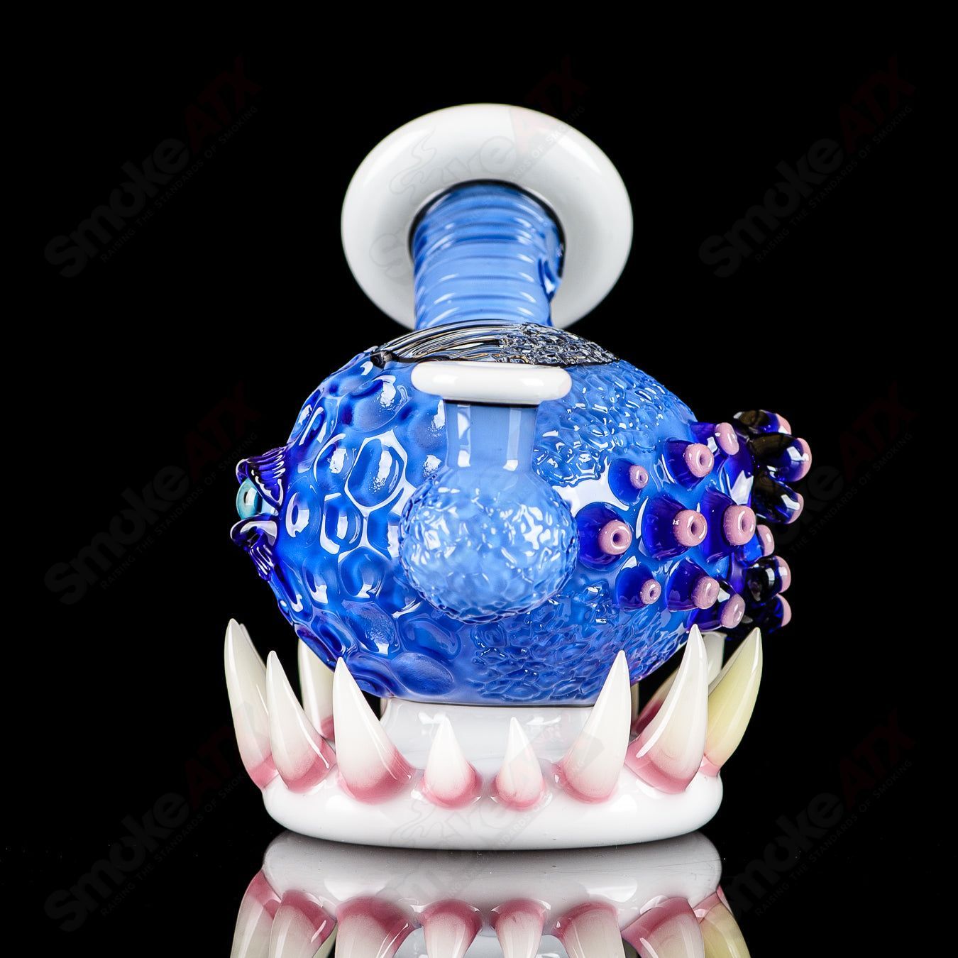 Brilliant blue orb-shaped concentrate rig by Salt Glass, heady glass piece with intricate design and clear glass accents.