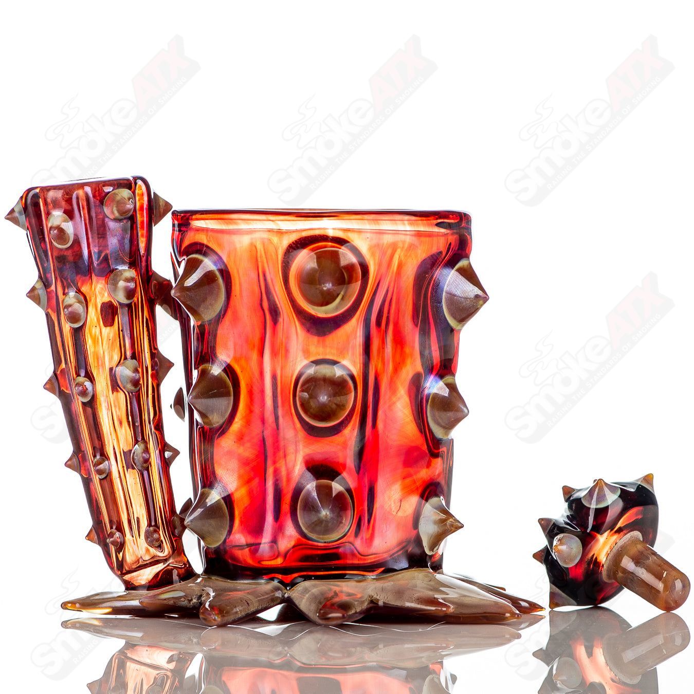 Red cactus-shaped glass Qtip jar by Unparalleled Glass, featuring unique heady design and clear glass construction.