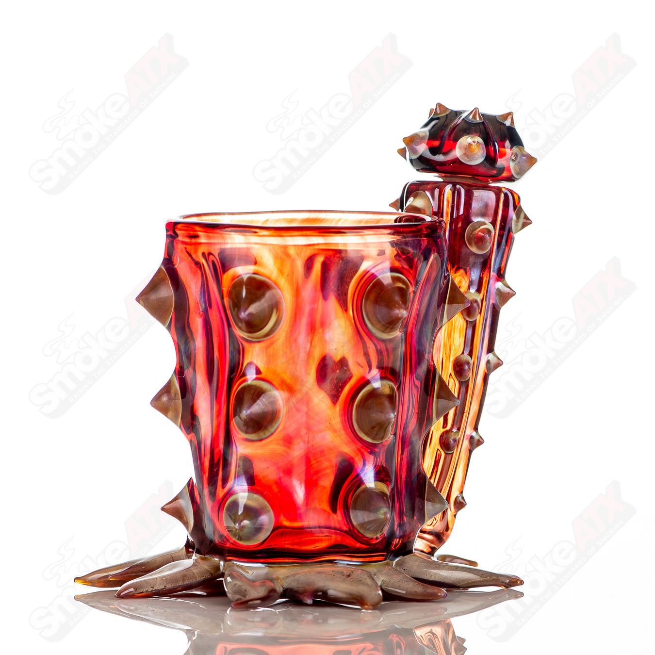 Red cactus-shaped Iso/Qtip jar by Unparalleled Glass, featuring vibrant heady glass design and clear glass construction.