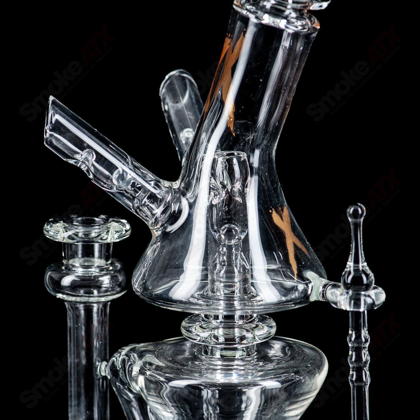 Clear Xhalecycler RAM Robert Mickelsen glass heady recycler with intricate design and transparent glass construction.