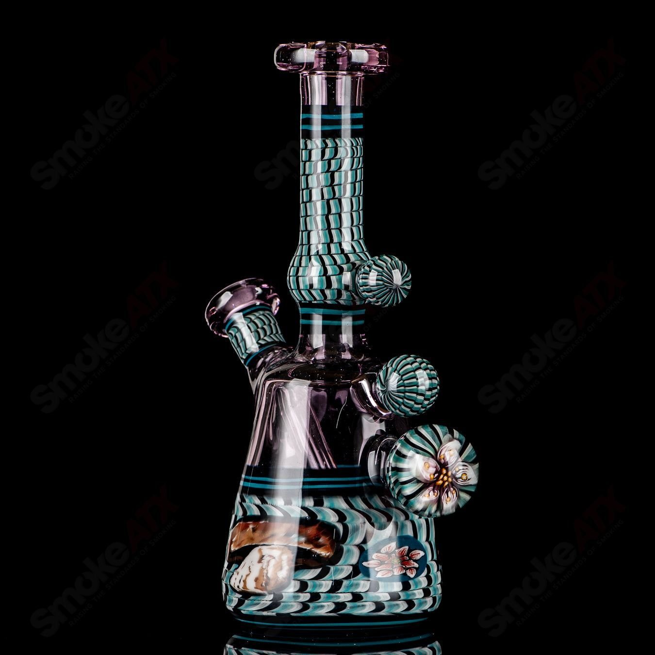 Coiled Latticello Milli Rig by Conversion Glass, a colorful heady glass concentrate rig with intricate coil design and vibrant accents.
