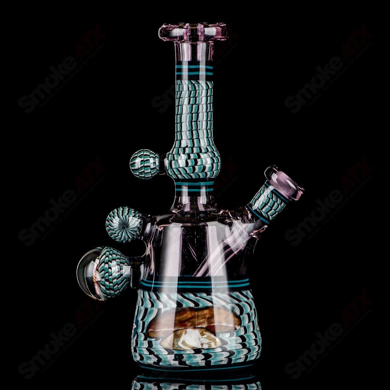 Coiled Latticello Milli Rig by Conversion Glass, a colorful heady glass concentrate rig with intricate coil design and vibrant details.