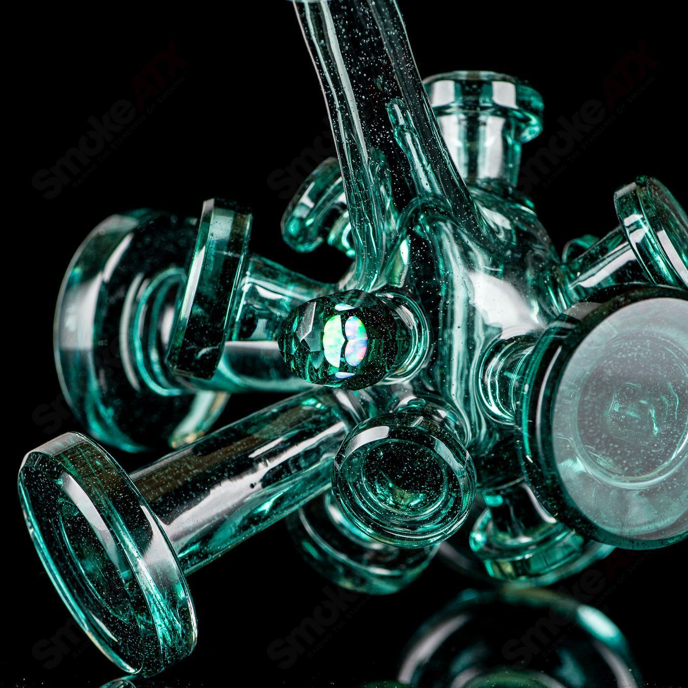 Color Spore Rig by JMass, a heady glass concentrate rig with vibrant, swirling colors and intricate glasswork design.
