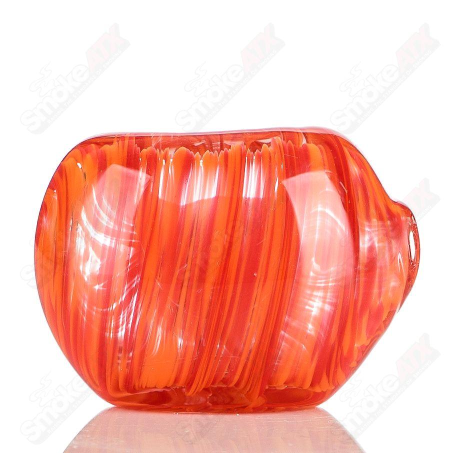Color worked red and orange glass spoon pipe signed by JMK Glass, featuring intricate color patterns and smooth glass finish.