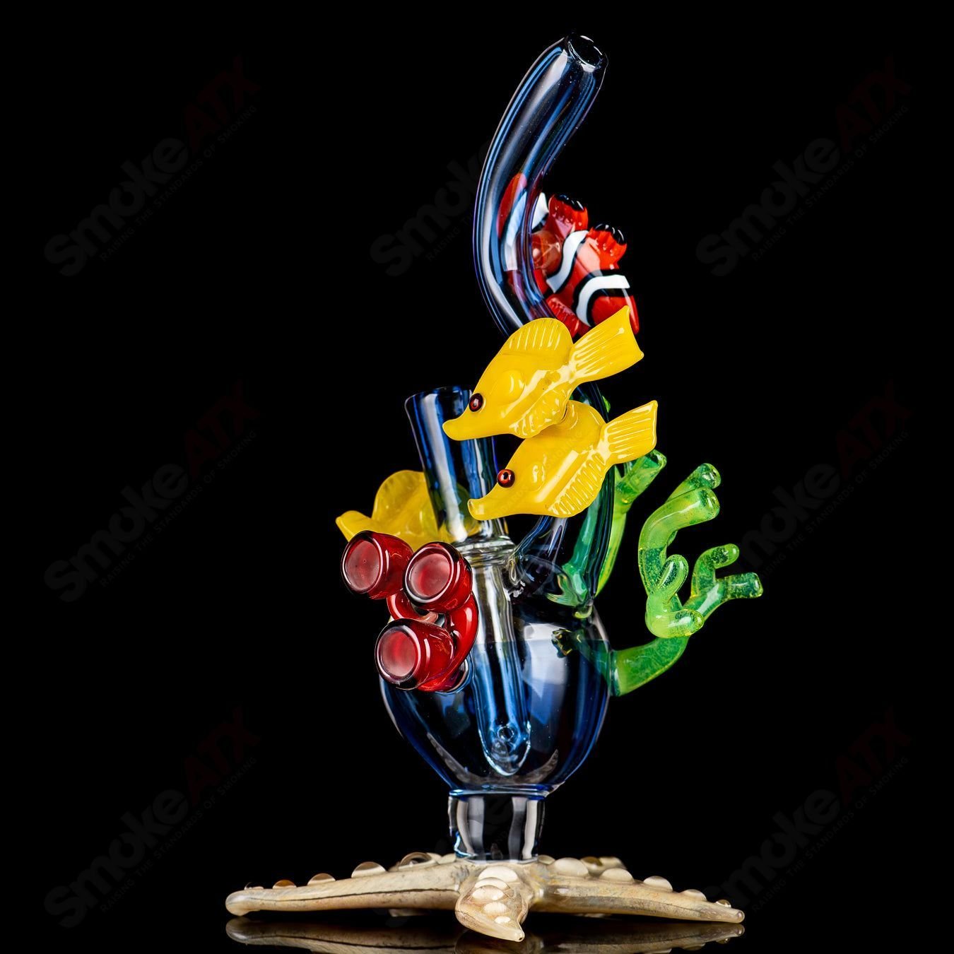 JRod Glass Coral Reef Rig, a colorful heady glass concentrate rig with intricate coral reef design and clear glass accents.
