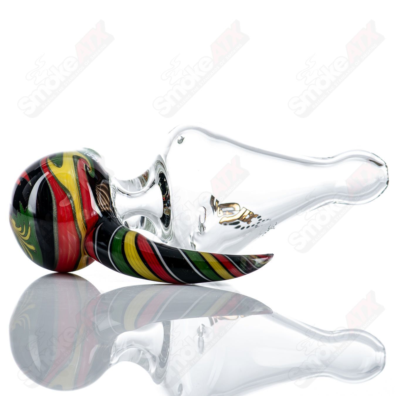 Custom Rasta medium helix glass spoon pipe by Smoke ATX with colorful Rasta design and intricate helix pattern.