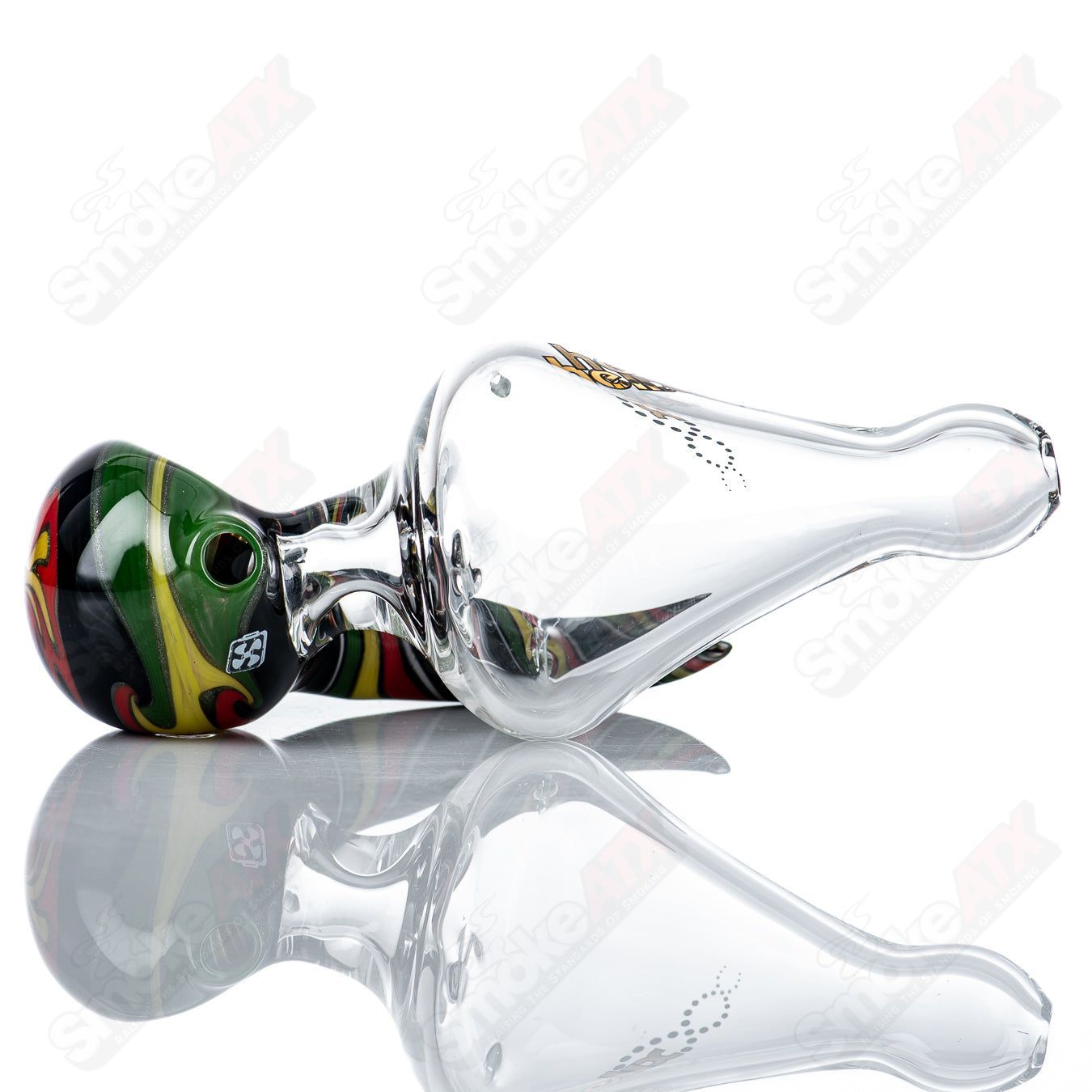 Custom Rasta Medium Helix Glass Spoon Pipe by Smoke ATX featuring colorful Rasta design and spiral pattern on a clear glass surface.