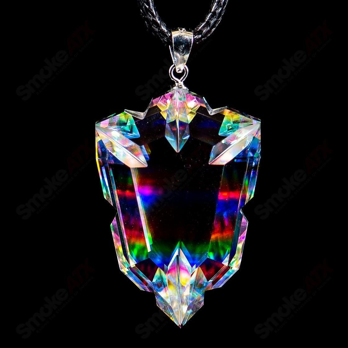 Dichro Arrow Head Faceted Pendant by Fatal Facets, colorful glass head with faceted surface, set against a neutral background