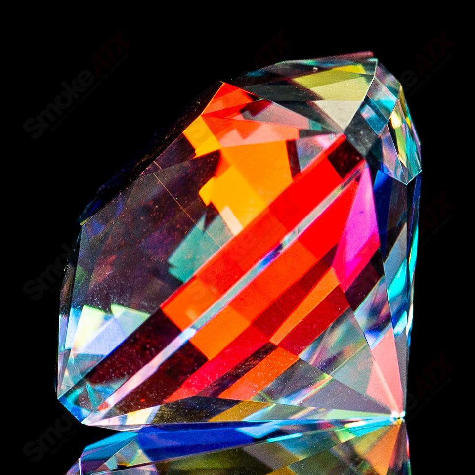 Colorful Dichro Gem Fatal Facets heady glass marble with shimmering, iridescent surface and intricate faceted design.