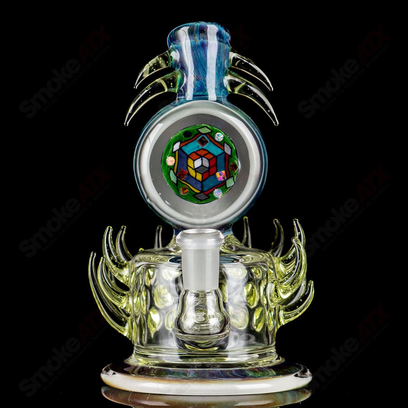 Colorful Freeek Glass Disc Rig in lime and purple for concentrates, featuring a sleek heady glass design.