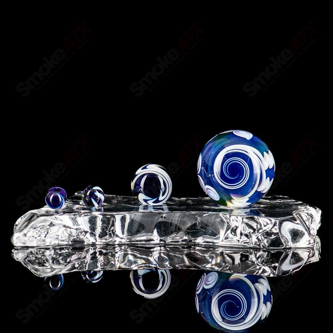Indo Glass UV Dotstack Slurper Set featuring colorful glass tools for dabbing and concentrates, with vibrant dot patterns.
