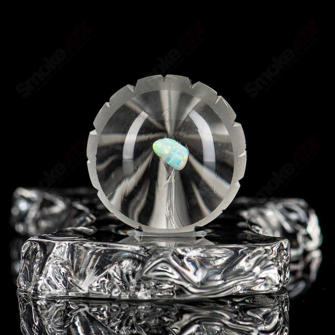 Close-up of Gemini Fatal Facets marble by Fatal Facets, showcasing its clear glass with intricate marble patterns and facets.