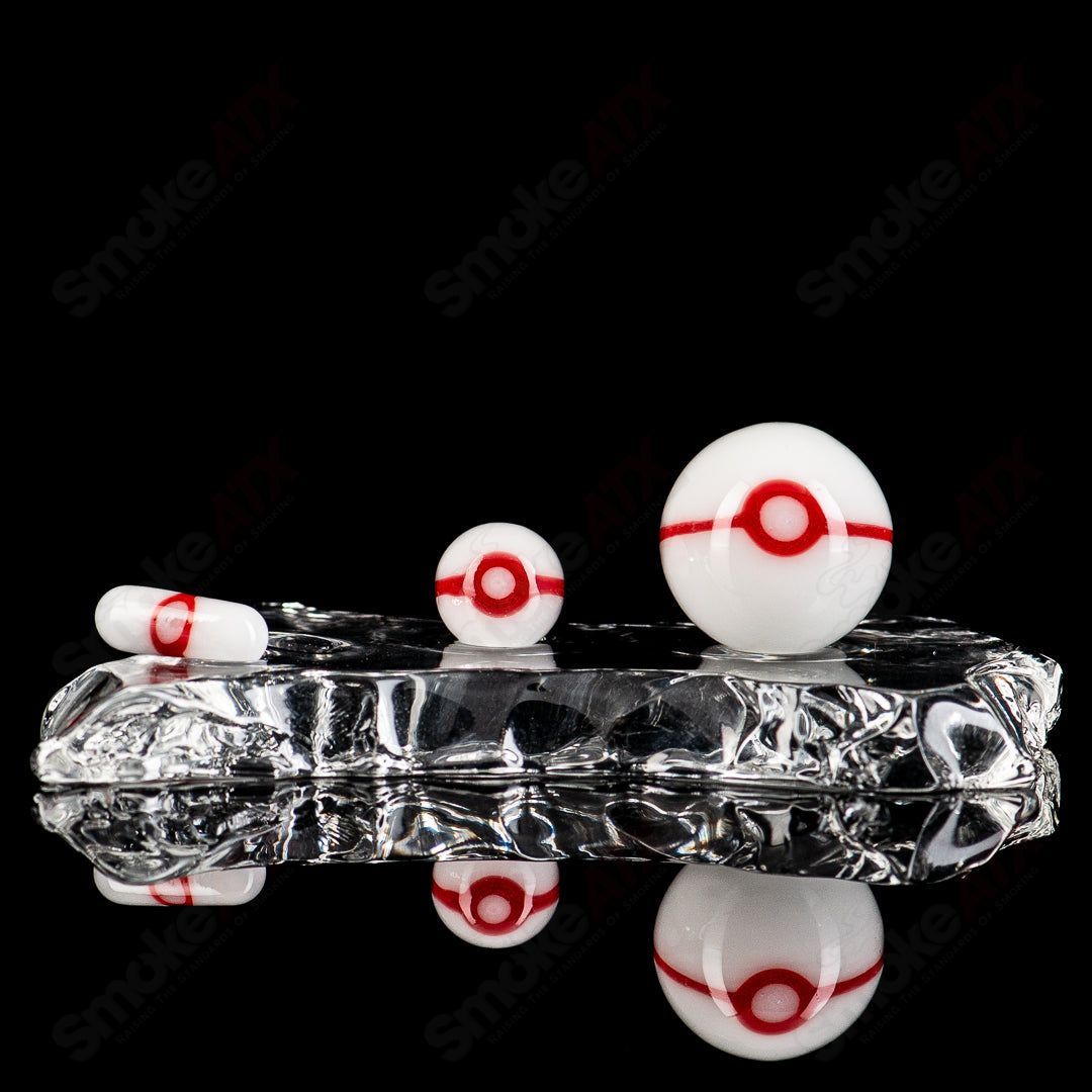 Three-piece glass Pokeball terp slurper set by Ganja Grimmlin Glass, featuring colorful, detailed Pokeball designs for dabbing.