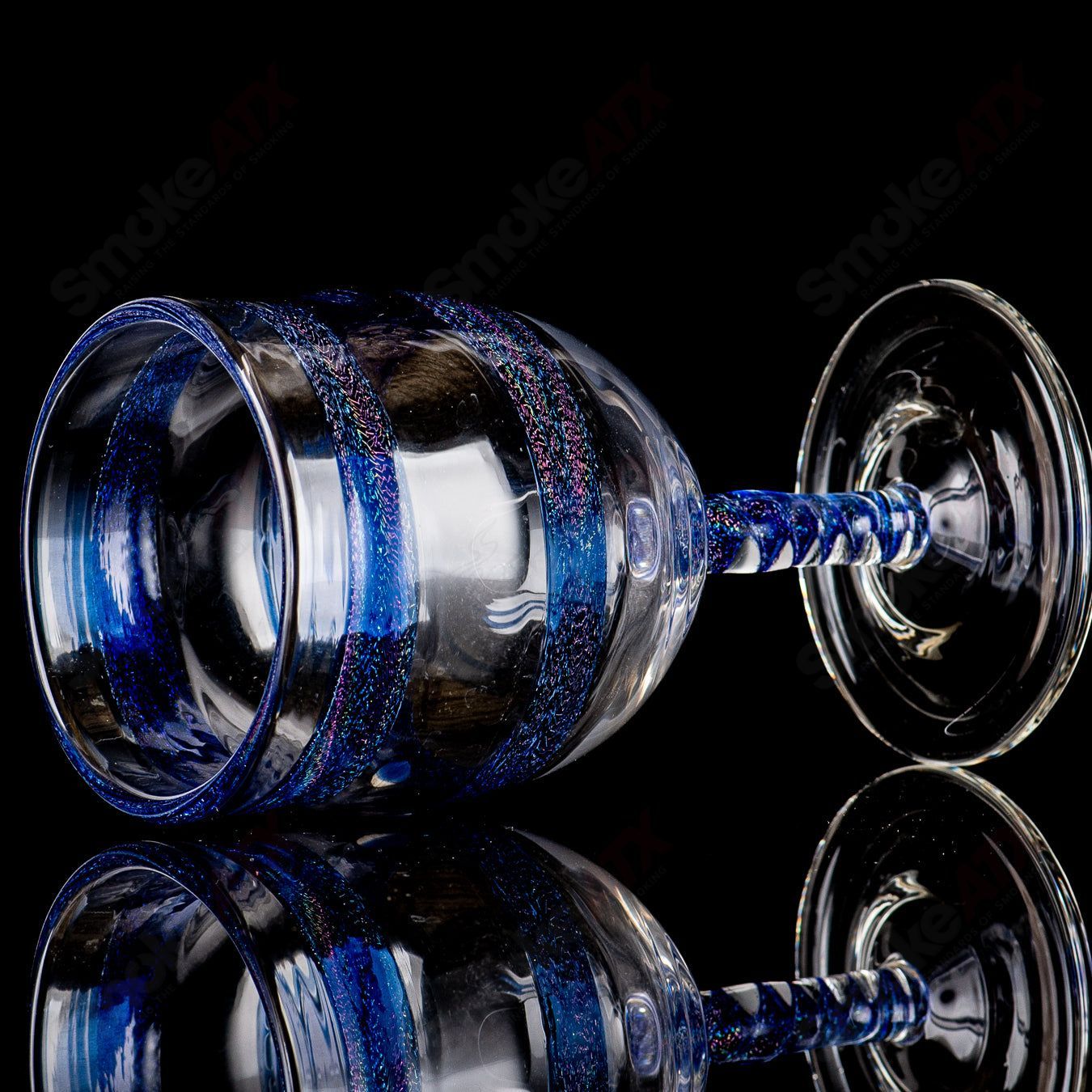 Footed blue dichro spiral stem drinking goblet made of heady glass with vibrant, colorful glasswork and intricate spiral design.