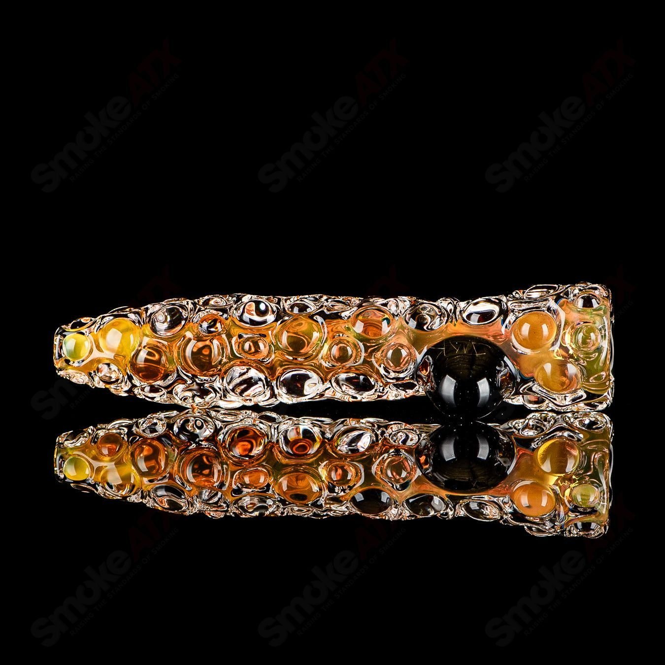 Fumed hobnail glass chillum with black dot signature by JMK Glass, featuring textured hobnail design and smoked fumed finish.