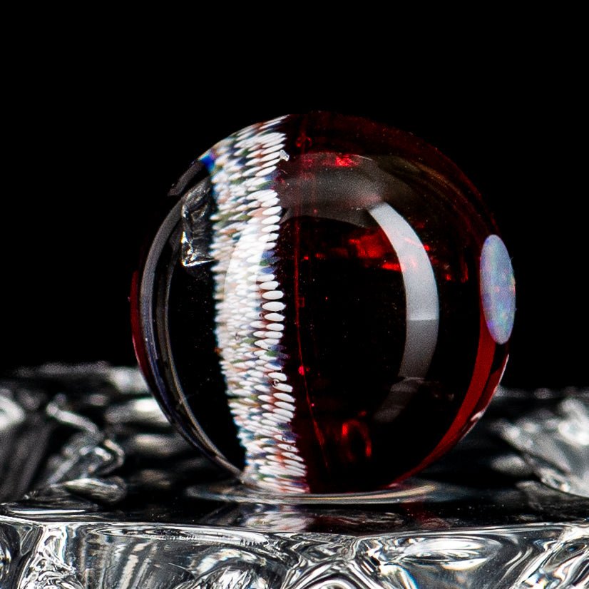 Geometric Slurper marble art piece by JH Glassworks showcasing vibrant, swirling patterns and intricate glasswork details.