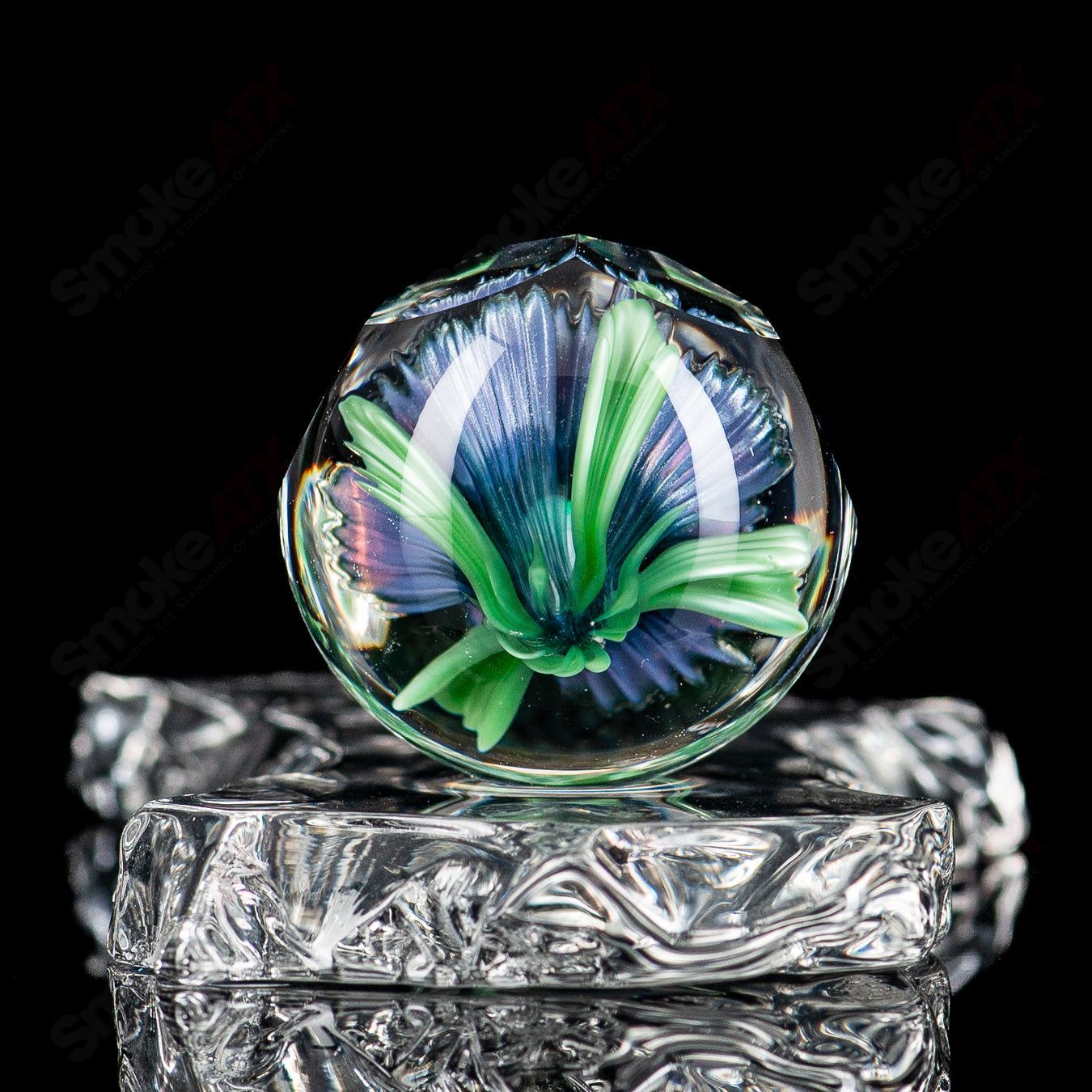 Close-up of Flower Marble #2 by Fatal Facets, a glass marble featuring a colorful floral design with intricate glasswork.