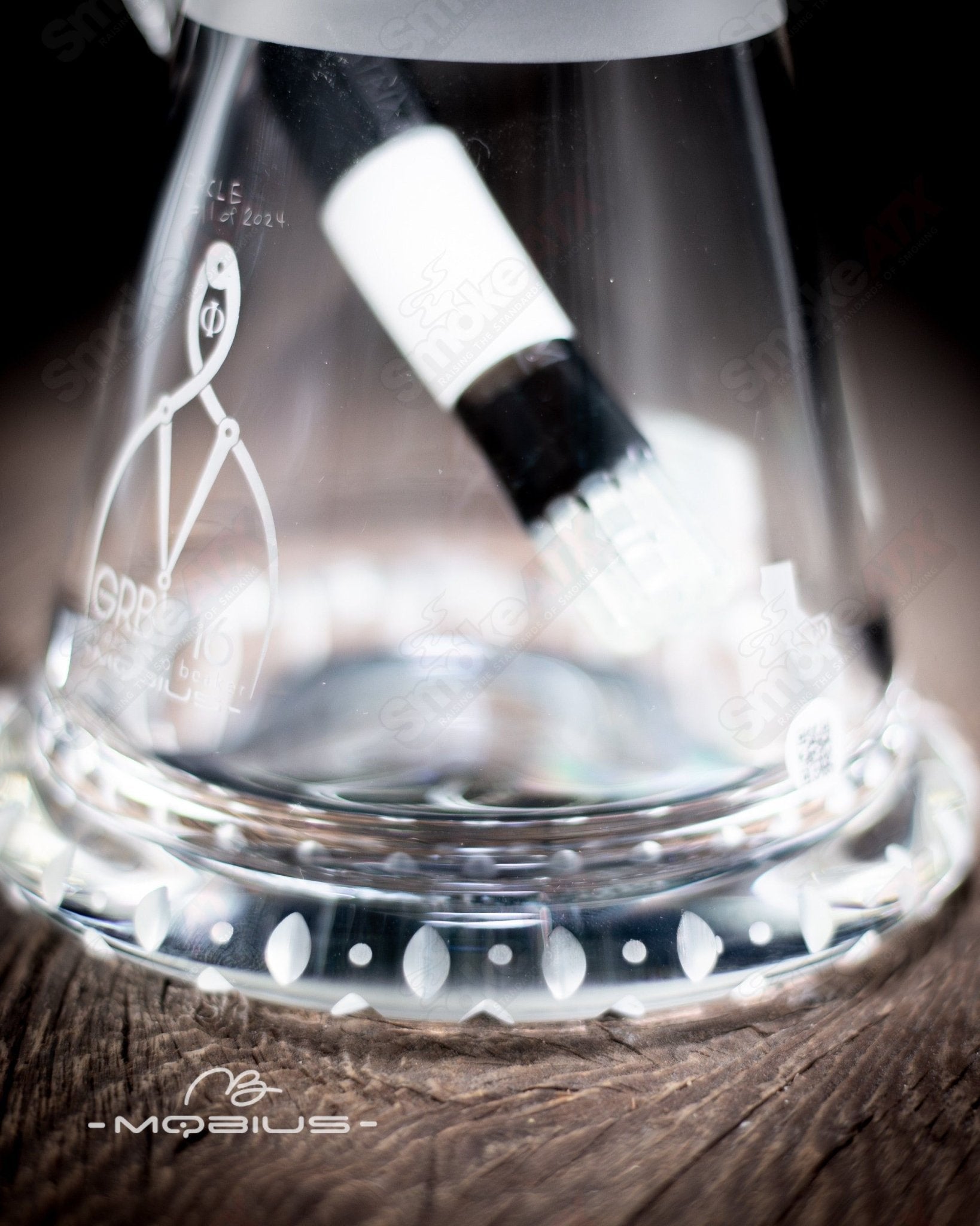Mobius GRB 16 Circle Solo signed #11 of 2024 glass beaker, clear laboratory-style glass with printed markings and signature.
