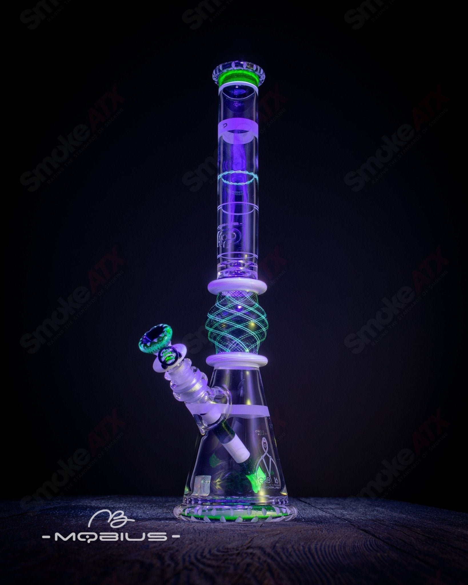 Mobius GRB 16 Circle Solo signed glass beaker with #11 of 2024 inscription, clear glass with a rounded shape.