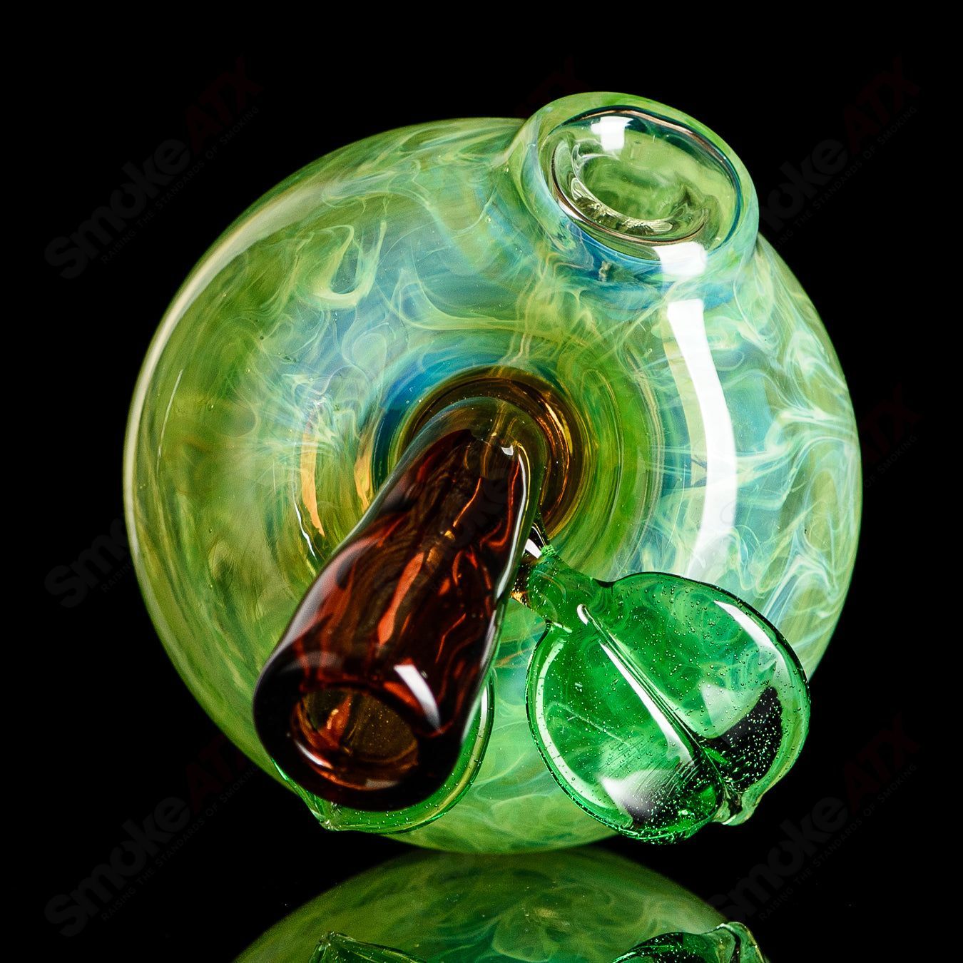 Green apple-shaped concentrate rig with a worm dabber and pouch, made by Pouch Glass, featuring vibrant green glass and detailed design.