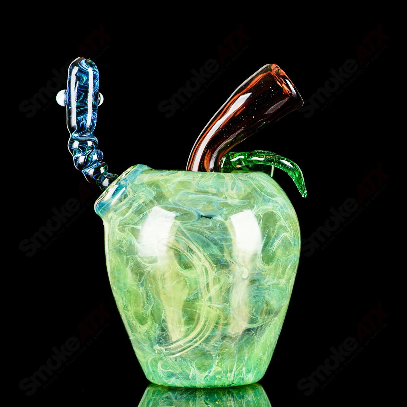 Green apple-shaped concentrate rig with a worm dabber pouch, made by Pouch Glass, featuring clear glass construction and detailed design.